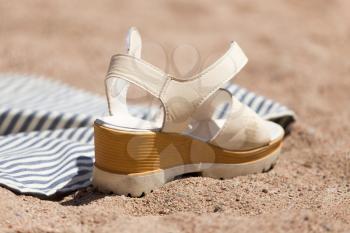 white shoes on the sand
