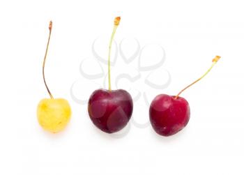 red and yellow cherries on white background