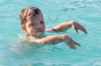 Boy swims in the water park