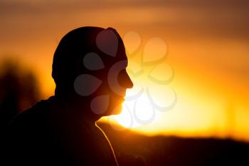 silhouette of a man with glasses on sunset
