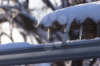 Long and dangerous icicles on a house roof