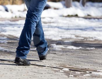 foot man walking on the road in winter