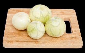 onions on a board on a black background