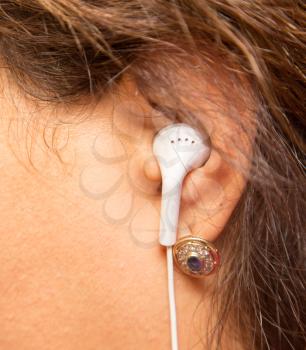 earphone in girls ear. macro . A photo