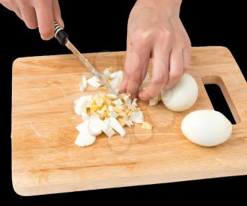 cook eggs on cutting board on a black background .