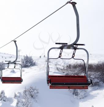 Ski lift in the mountains in winter .