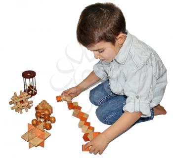 Boy with many wooden logic toys
