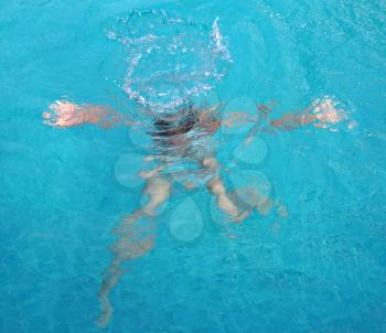 Royalty Free Photo of a Girl Swimming in a Pool