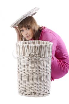 Royalty Free Photo of a Woman by a Laundry Hamper