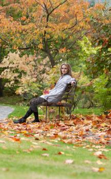 Royalty Free Photo of a Woman Sitting on a Bench