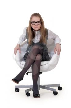 Royalty Free Photo of a Young Woman Sitting in a Chair