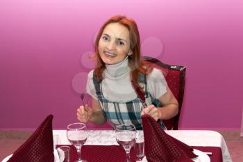 Royalty Free Photo of a Woman Sitting at a Table