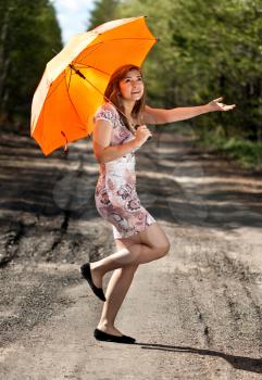 Royalty Free Photo of a Girl Holding an Umbrella