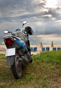 Royalty Free Photo of a Motorcycle by the Beach