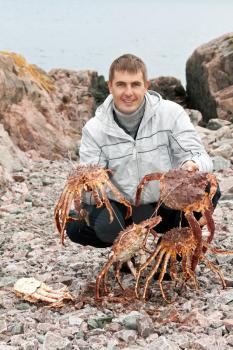 Royalty Free Photo of a Man Holding Crabs