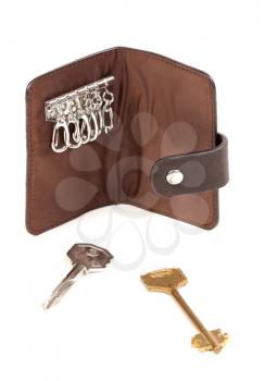 Brown purse for the keys with two keys. Isolate on white.