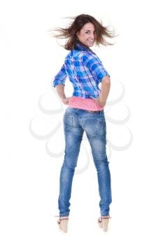 Beautiful girl in jeans turns out to back on a white background