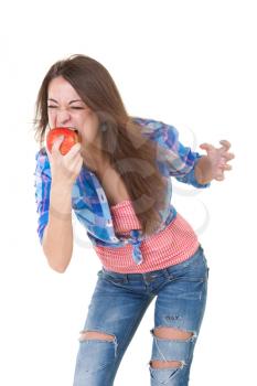 Girl eating an apple in a frenzy. Isolate on white