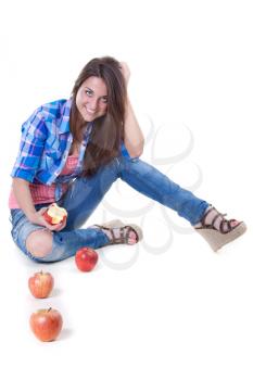 beautiful young woman in jeans with the apples in the studio on a white background
