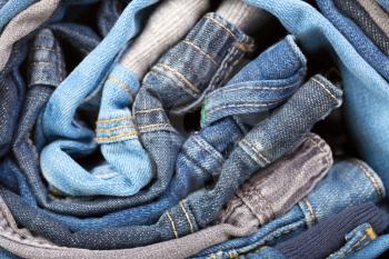 stack of various jeans, background