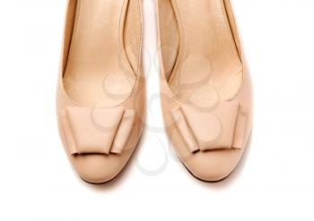 Pair of women's shoes leather beige closeup. Isolate on white.
