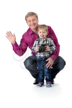 Father and young son with a camera in the studio isolate on white background.