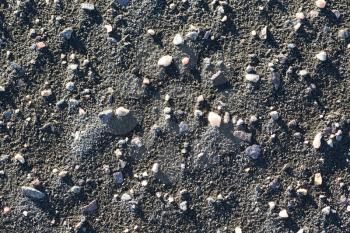 Background, black sand and pebbles