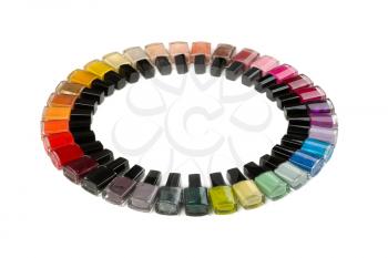 Bottles with nail polish arranged in a circle. Isolate on white.