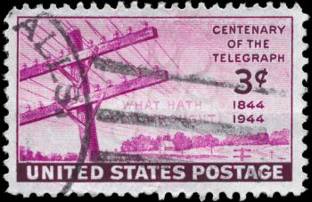Royalty Free Photo of a 1944 US Stamp With Telegraph Wires and the First Transmitted Words 100th Anniversary