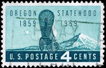 Royalty Free Photo of 1959 US Stamp Shows a Covered Wagon and Mount Hood, Oregon Statehood Centenary