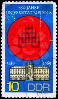 GDR - CIRCA 1969: A Stamp printed in GDR shows the image of a Rostock University - Seal and Building, circa 1969