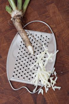 Royalty Free Photo of a Horseradish Root and Grater