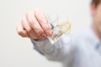 Royalty Free Photo of a Man Holding a Condom