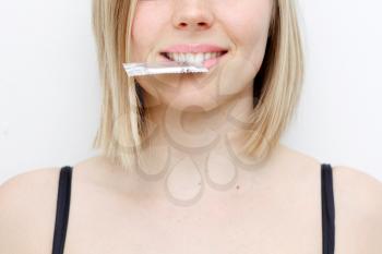 Royalty Free Photo of a Woman With a Condom in Her Mouth