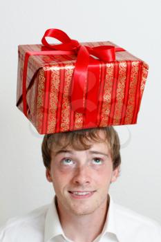 Royalty Free Photo of a Man With a Present on His Head