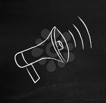 Royalty Free Photo of a Megaphone on a Chalkboard