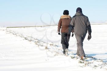Royalty Free Photo of a Couple Walking in the Snow