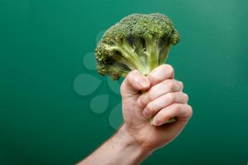 Royalty Free Photo of a Person Holding Broccoli
