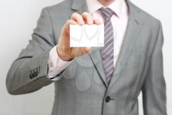 Royalty Free Photo of a Businessman Holding a Card