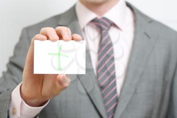 Royalty Free Photo of a Businessman Holding a Wind Turbine Card