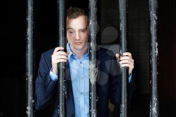 Royalty Free Photo of a Businessman in Jail