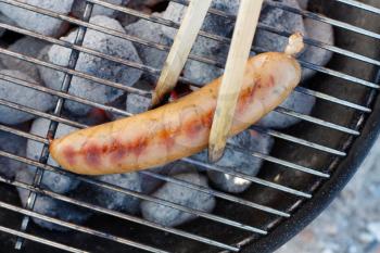 Royalty Free Photo of a Sausage on a Barbecue