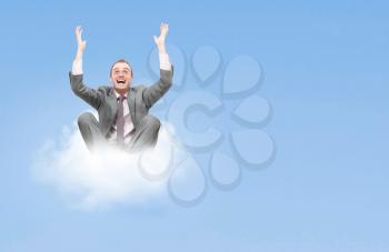 Royalty Free Photo of a Businessman on a Cloud