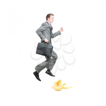 Businessman about to slip in bananapeel