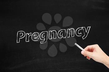 Pregnancy written on a blackboard