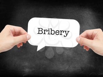 Bribery written on a speechbubble