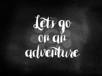 Let’s go on an adventure written on a chalkboard