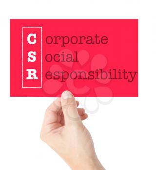 Corporate Social Responsibility explained on a card held by a hand