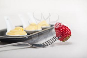 custard pastry cream and strawberry on a fork