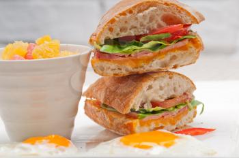 fresh ciabatta panini sandwich with eggs tomato lettuce